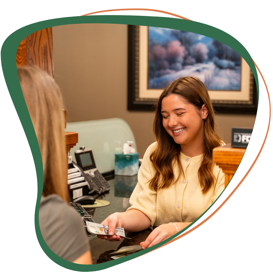 Female banker handing money to client